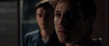 Movie still from “On the Road” (2012), directed by Walter Salles – A man with a beard is looking at the camera; Close Up shot, Over the shoulder angle