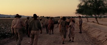 Movie still from “On the Road” (2012), directed by Walter Salles – A group of people walking down a dirt road; Wide shot, Low angle