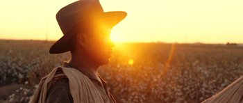 Movie still from “On the Road” (2012), directed by Walter Salles – A man wearing a cowboy hat standing in front of a field of cotton; Close Up shot, Low angle