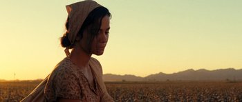 Movie still from “On the Road” (2012), directed by Walter Salles – A woman in a field with a scarf around her head; Medium shot, Low angle
