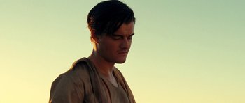 Movie still from “On the Road” (2012), directed by Walter Salles – A young man with short black hair is looking to his left; Close Up shot, Low angle