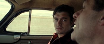 Movie still from “On the Road” (2012), directed by Walter Salles – A person in a car looking at the camera; Close Up shot, Over the shoulder angle