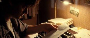Movie still from “On the Road” (2012), directed by Walter Salles – A person is reading a book on a typewriter; Close Up shot, High angle