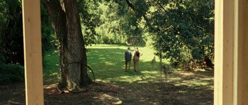 Movie still from “On the Road” (2012), directed by Walter Salles – Two people standing under a tree in a field; Extreme Wide shot, High angle