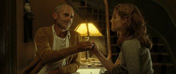 Movie still from “On the Road” (2012), directed by Walter Salles – An older man and a young woman are holding hands; Medium shot, Low angle