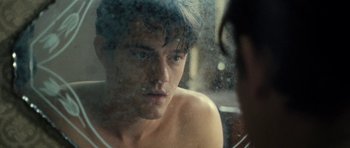 Movie still from “On the Road” (2012), directed by Walter Salles – A man looking into a bathroom mirror with his eyes wide open; Close Up shot, Over the shoulder angle