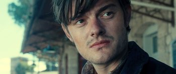 Movie still from “On the Road” (2012), directed by Walter Salles – A person wearing a jacket; Close Up shot, Over the shoulder angle