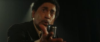 Movie still from “On the Road” (2012), directed by Walter Salles – A man holding a microphone in front of him; Close Up shot, Low angle