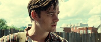 Movie still from “On the Road” (2012), directed by Walter Salles – A person wearing a plaid shirt; Close Up shot, Low angle