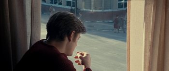 Movie still from “On the Road” (2012), directed by Walter Salles – A man sitting in front of a building looking out the window; Close Up shot, Over the shoulder angle