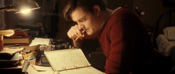 Movie still from “On the Road” (2012), directed by Walter Salles – A man with a pencil and a notebook; Medium shot, Low angle