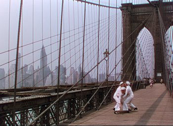 Movie still from “On the Town” (1949), directed by Gene Kelly – A group of people standing on top of a wooden bridge; Extreme Wide shot, Low angle