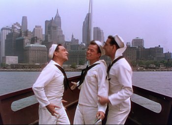 Movie still from “On the Town” (1949), directed by Gene Kelly – A group of men standing next to each other on top of a boat; Wide shot, High angle