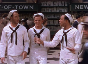 Movie still from “On the Town” (1949), directed by Gene Kelly – A group of men in sailor's outfits standing next to each other; Wide shot, High angle