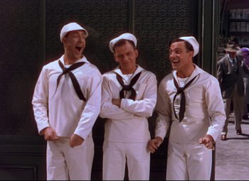 Movie still from “On the Town” (1949), directed by Gene Kelly – A group of men standing next to each other wearing sailor suits; Medium shot, Low angle