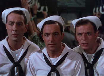 Movie still from “On the Town” (1949), directed by Gene Kelly – A group of men in sailor's outfits standing next to each other; Close Up shot, Low angle