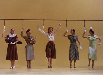 Movie still from “On the Town” (1949), directed by Gene Kelly – A group of women standing next to each other; Wide shot, Low angle