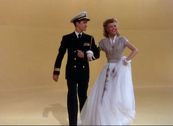 Movie still from “On the Town” (1949), directed by Gene Kelly – A man and a woman dressed in military uniforms; Medium shot, Low angle