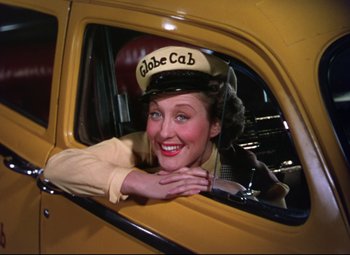 Movie still from “On the Town” (1949), directed by Gene Kelly – A woman sitting in the driver's seat of a taxi cab; Medium shot, Low angle