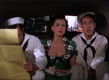 Movie still from “On the Town” (1949), directed by Gene Kelly – A group of people sitting in the back of a car; Medium shot, High angle