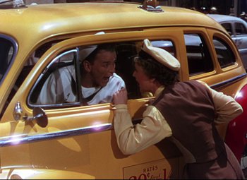 Movie still from “On the Town” (1949), directed by Gene Kelly – A man and a woman in a yellow taxi cab; Medium shot, Over the shoulder angle