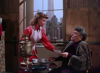 Movie still from “On the Town” (1949), directed by Gene Kelly – An older woman sitting at a table next to an older woman; Medium shot, Over the shoulder angle
