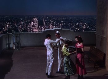 Movie still from “On the Town” (1949), directed by Gene Kelly – A group of people standing on top of a building; Extreme Wide shot, High angle
