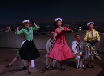 Movie still from “On the Town” (1949), directed by Gene Kelly – A group of people dressed in sailor outfits; Wide shot, Low angle