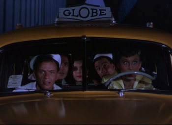 Movie still from “On the Town” (1949), directed by Gene Kelly – A group of people in a yellow taxi car; Medium shot, Low angle