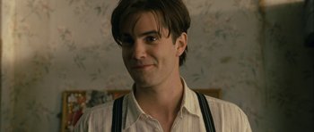 Movie still from “One Day” (2011), directed by Lone Scherfig – A person wearing suspenders; Close Up shot, Over the shoulder angle