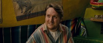 Movie still from “One Day” (2011), directed by Lone Scherfig – A person sitting on a chair; Close Up shot, Low angle