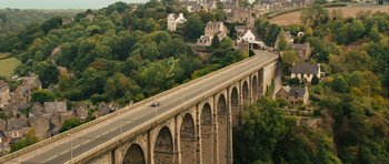 Movie still from “One Day” (2011), directed by Lone Scherfig – An aerial view of a bridge with cars driving on it; Extreme Wide shot, High angle
