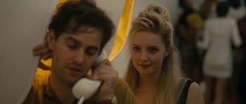 Movie still from “One Day” (2011), directed by Lone Scherfig – A woman holding a phone up to a man's ear; Close Up shot, Over the shoulder angle