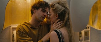 Movie still from “One Day” (2011), directed by Lone Scherfig – A man and a woman are kissing in a dimly - lit room; Close Up shot, Over the shoulder angle