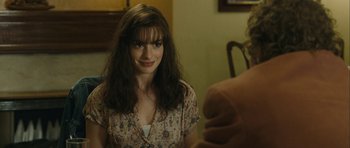 Movie still from “One Day” (2011), directed by Lone Scherfig – A woman sitting at a dining room table; Close Up shot, Over the shoulder angle