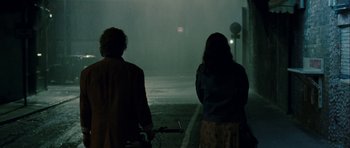 Movie still from “One Day” (2011), directed by Lone Scherfig – A man and a woman standing next to each other on a street; Medium shot, Over the shoulder angle