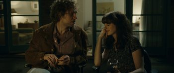 Movie still from “One Day” (2011), directed by Lone Scherfig – A man and a woman sitting next to each other at a table; Close Up shot, Over the shoulder angle