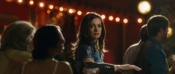 Movie still from “One Day” (2011), directed by Lone Scherfig – A beautiful young woman sitting in front of a group of people; Close Up shot, Over the shoulder angle