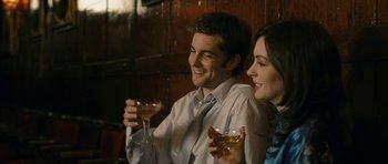 Movie still from “One Day” (2011), directed by Lone Scherfig – A man and a woman sitting next to each other holding wine glasses; Close Up shot, Over the shoulder angle