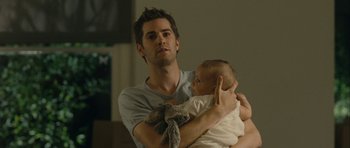 Movie still from “One Day” (2011), directed by Lone Scherfig – A man holding a baby in his arms; Medium shot, Over the shoulder angle