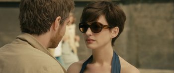 Movie still from “One Day” (2011), directed by Lone Scherfig – A man and a woman wearing sun glasses; Close Up shot, Over the shoulder angle