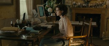 Movie still from “One Day” (2011), directed by Lone Scherfig – A woman sitting in front of a computer desk; Medium shot, High angle