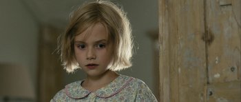 Movie still from “One Day” (2011), directed by Lone Scherfig – A little girl with blonde hair and a floral dress; Close Up shot, Over the shoulder angle