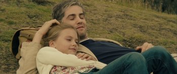Movie still from “One Day” (2011), directed by Lone Scherfig – A man and a little girl laying in the grass; Close Up shot, High angle