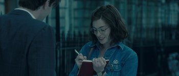 Movie still from “One Day” (2011), directed by Lone Scherfig – A woman writing in a notebook while holding a pen; Close Up shot, Over the shoulder angle