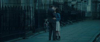 Movie still from “One Day” (2011), directed by Lone Scherfig – A man and a woman kissing on a sidewalk; Wide shot, High angle