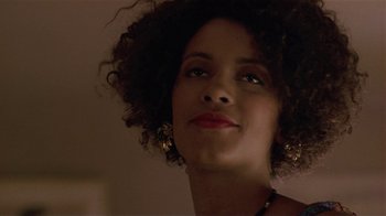 Movie still from “One False Move” (1991), directed by Carl Franklin – A person wearing a necklace and earrings; Close Up shot, Low angle