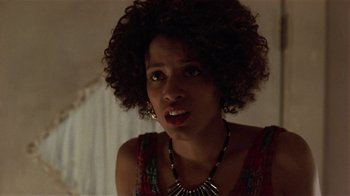 Movie still from “One False Move” (1991), directed by Carl Franklin – A person wearing a necklace; Close Up shot, Over the shoulder angle