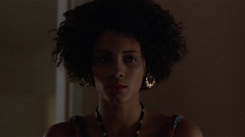 Movie still from “One False Move” (1991), directed by Carl Franklin – A woman with a very large afro is looking at the camera; Close Up shot, Low angle