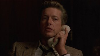 Movie still from “One False Move” (1991), directed by Carl Franklin – A person talking on a phone; Close Up shot, Low angle